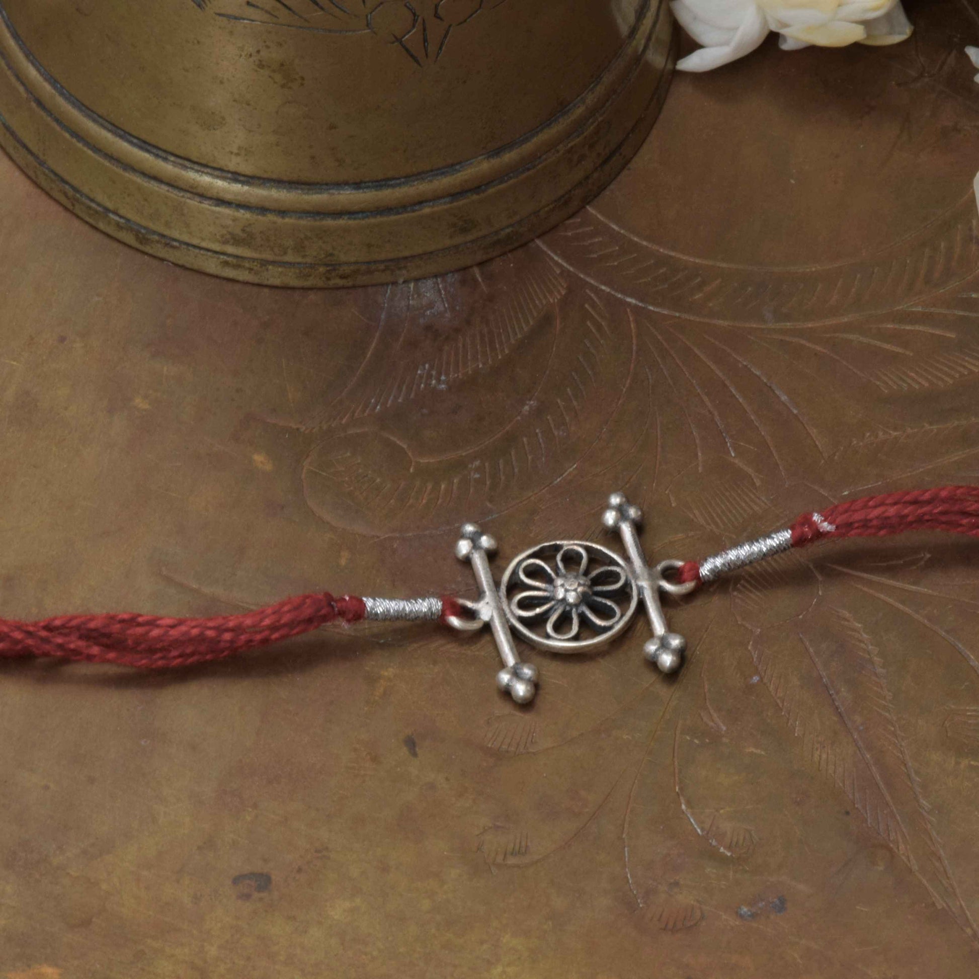 92.5 sterling silver Rakhi featuring real freshwater pearls and cotton thread,