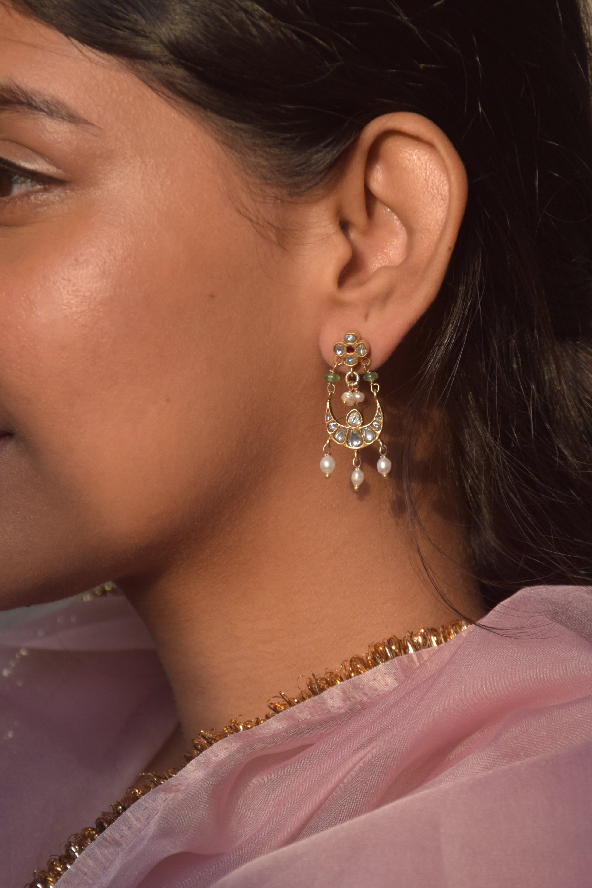 Nirjara Chandbali Earrings crafted in 925 silver, featuring lightweight floral studs adorned with small Jadau stones and a suspended chand design accented with hanging rice pearls.