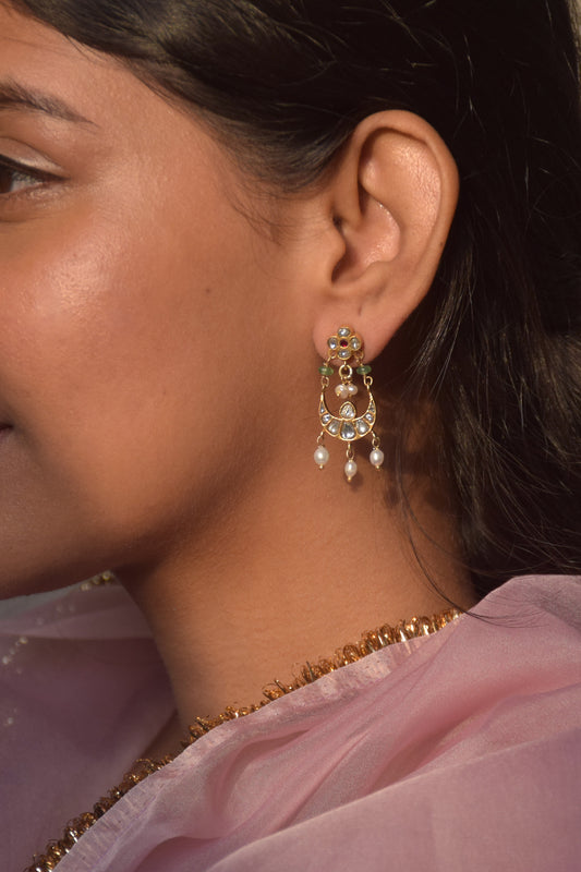 Nirjara Chandbali Earrings crafted in 925 silver, featuring lightweight floral studs adorned with small Jadau stones and a suspended chand design accented with hanging rice pearls.