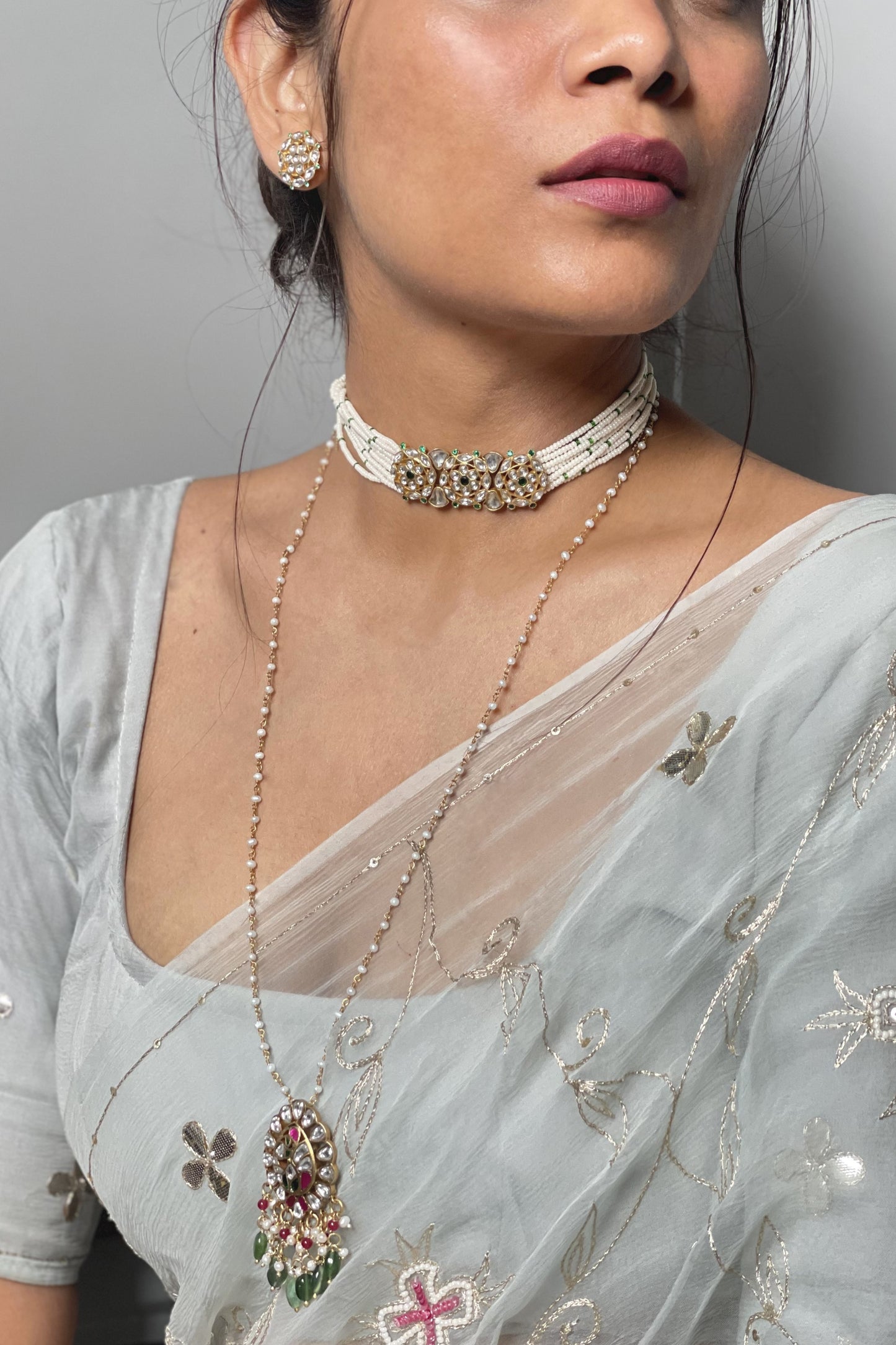 Phirni Choker crafted in 925 silver with a gold-polished finish, featuring three round Jadau stone units as the centerpiece and delicate strands of seed pearls