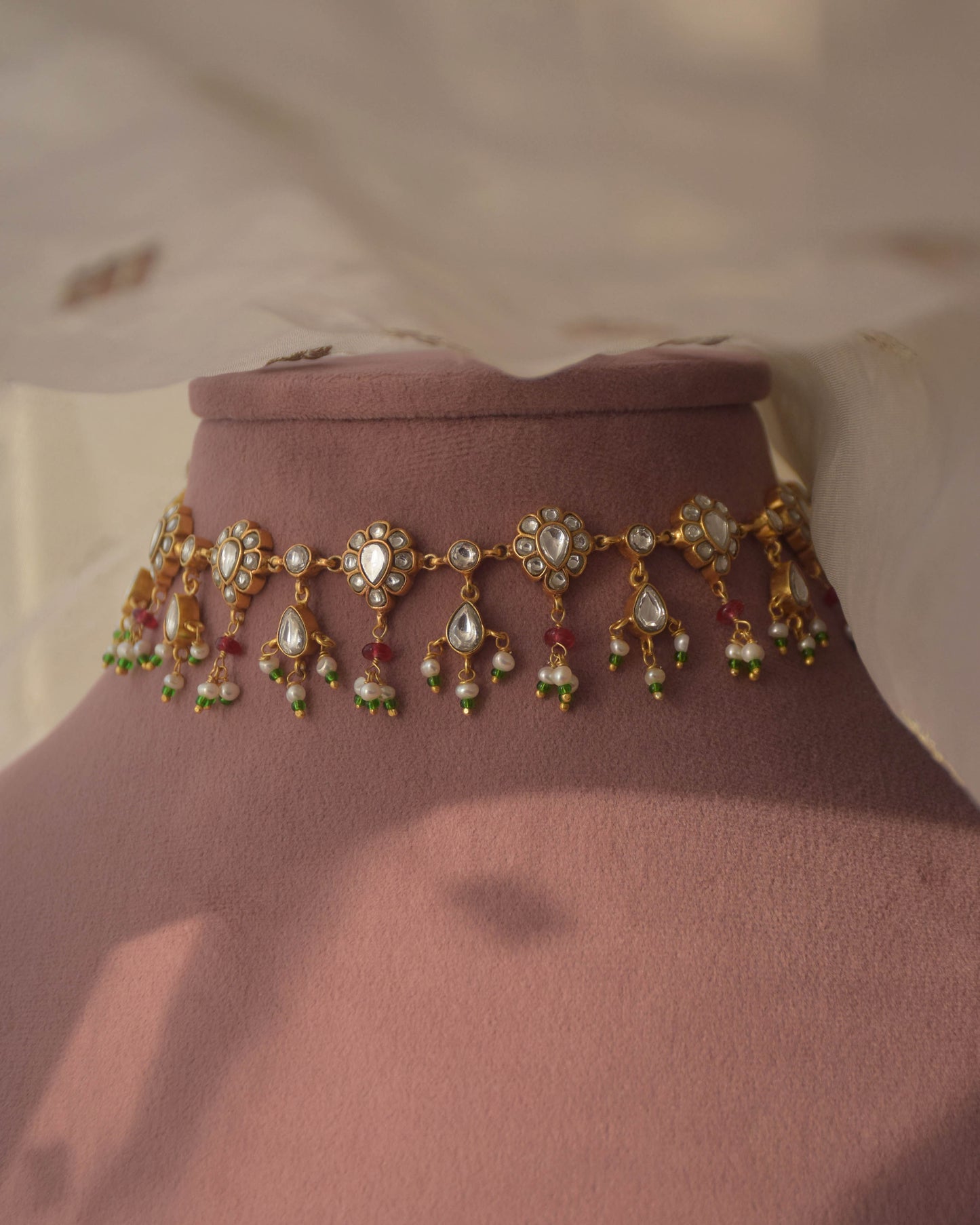 Sagrika Necklace crafted in 92.5 sterling silver, featuring drop-shaped jadau stone-studded motifs, adorned with delicate pearl drops and pink semi-precious beads.