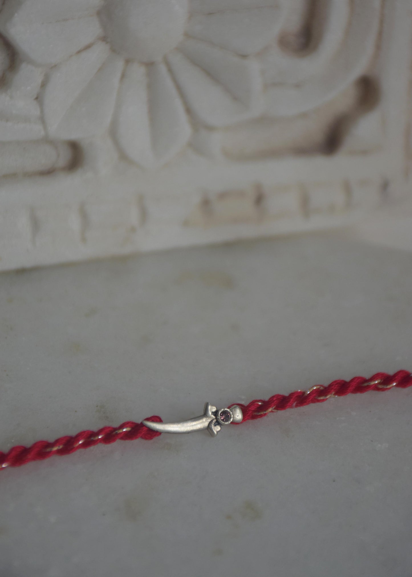 92.5 sterling silver Rakhi featuring real freshwater pearls and cotton thread,
