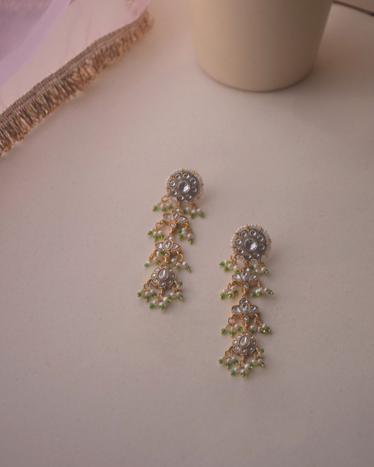 Dhanak Earrings crafted in 925 sterling silver featuring a round stud with four elegantly suspended units adorned with delicate hanging pearls.