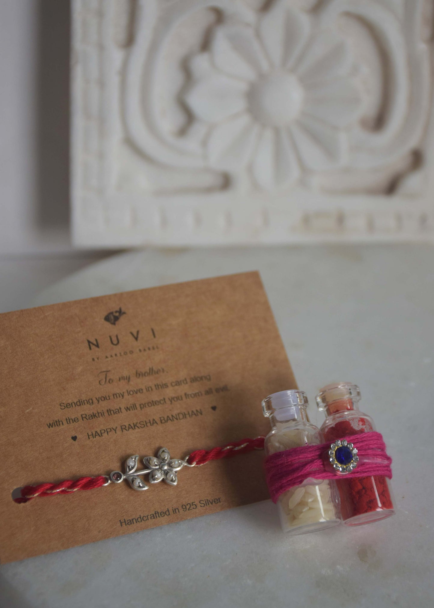 92.5 sterling silver Rakhi featuring real freshwater pearls and cotton thread,