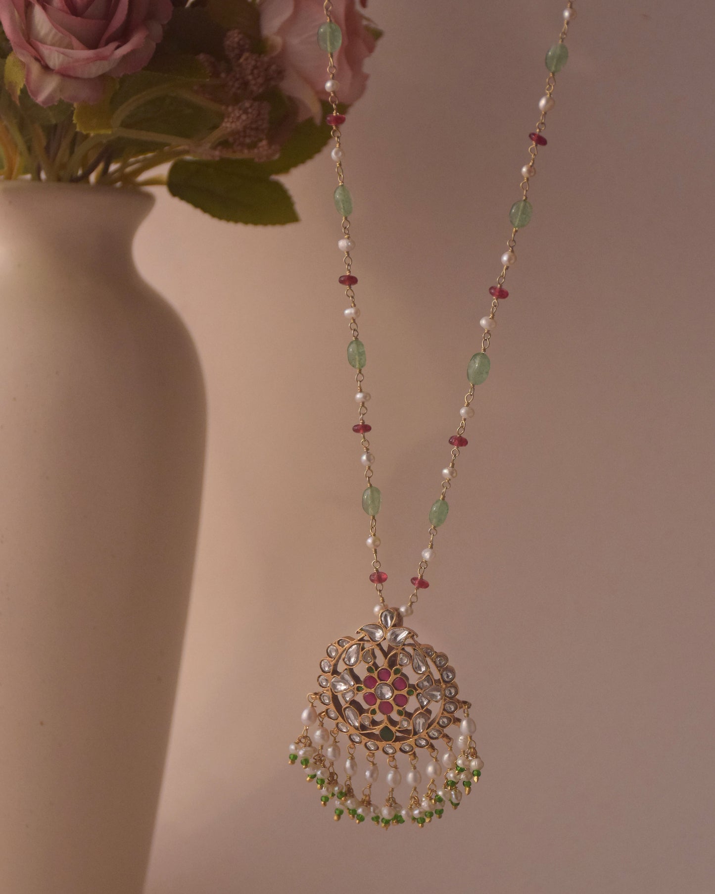 Elegant jadau necklace featuring tumbled Jadau White and Pink Stones in pearls on a delicate chain, with a finely studded jadau centerpiece and freshwater pearl hangings
