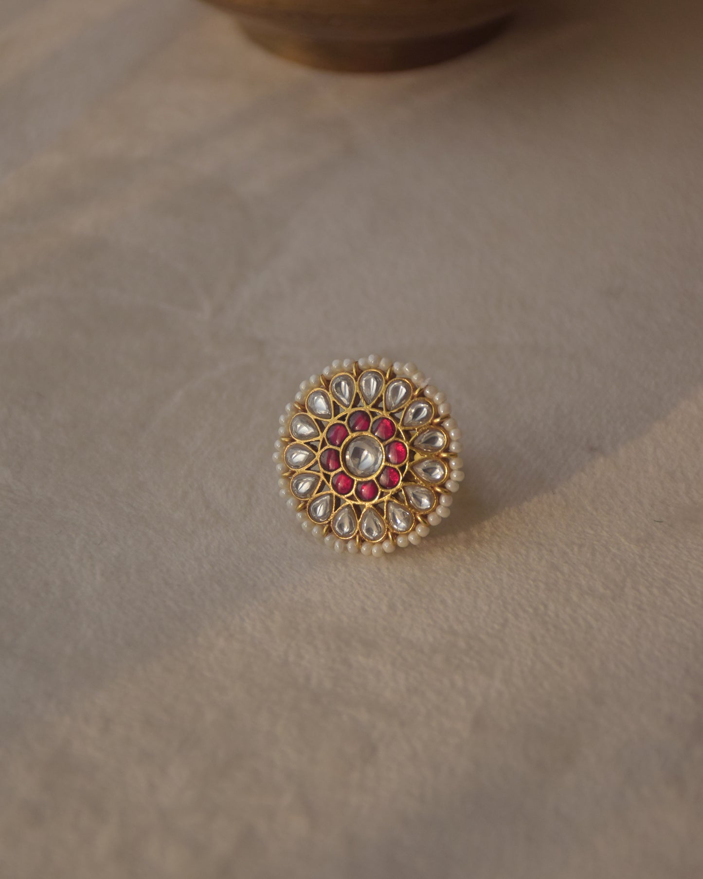 Mannhari RING - Crafted in 925 gold plated Silver has a Round Shape with White & Red Jadau Stones.