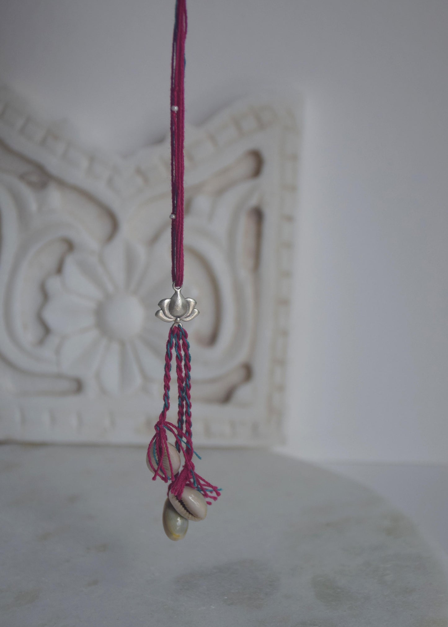 92.5 sterling silver Rakhi featuring real freshwater pearls and cotton thread,