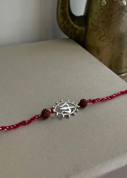 92.5 sterling silver Rakhi featuring real freshwater pearls and cotton thread,