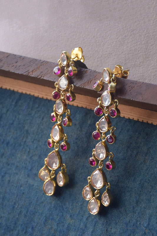 Boondan Polki Earrings featuring shiny Polki drops arranged in ascending order, accented with small pink AD stones that dangle elegantly. Crafted for graceful movement and eye-catching style, these 925 silver statement earrings.