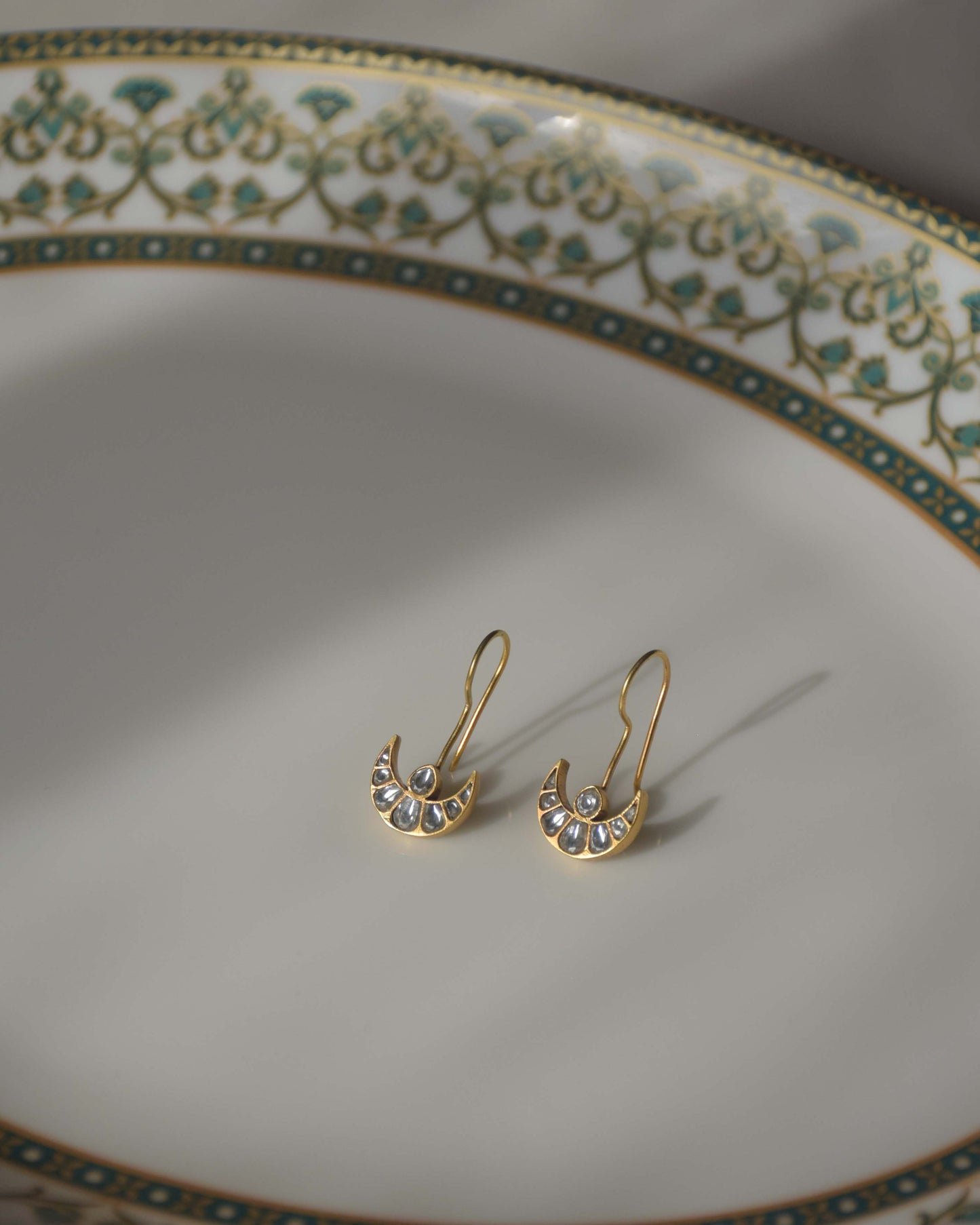 Chand Fish Hoop Earrings featuring a minimalistic design with Jadau chand elements adorned with pristine white Jadau stones.