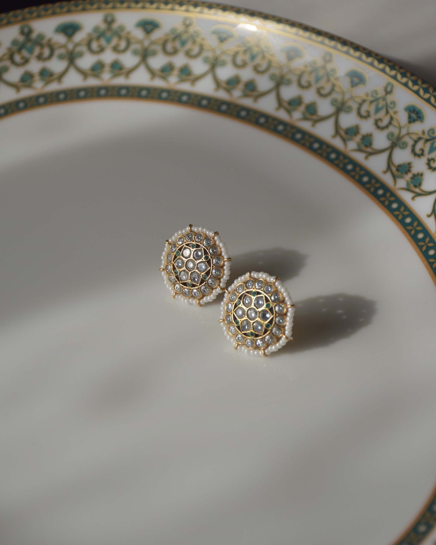 Classic 925 silver ear studs featuring intricate white Jadau stones arranged in a round floral design, accented with a delicate border of seed pearls