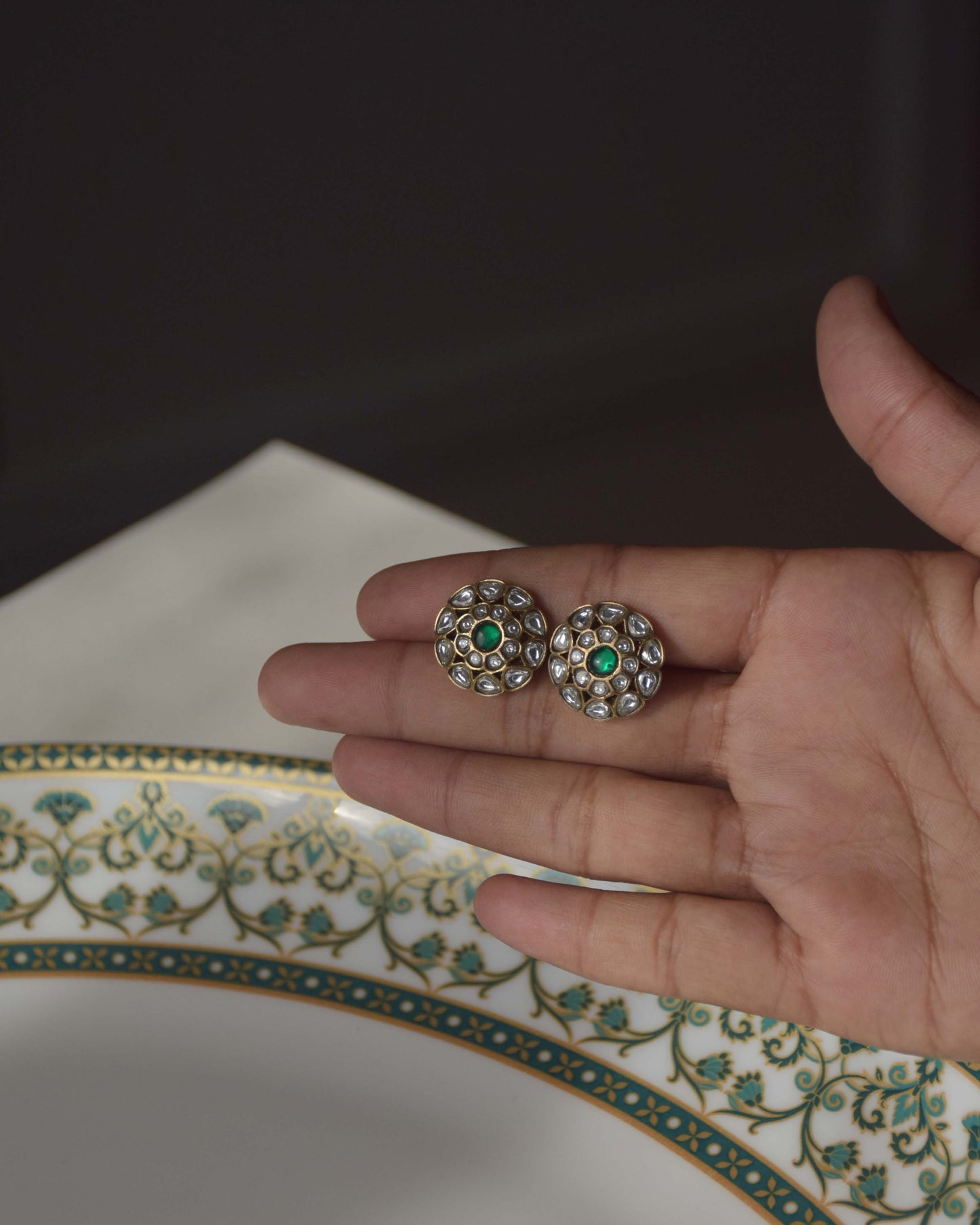 Classic gold-plated ear studs crafted in 925 silver, featuring a round floral design with intricate white Jadau stones.