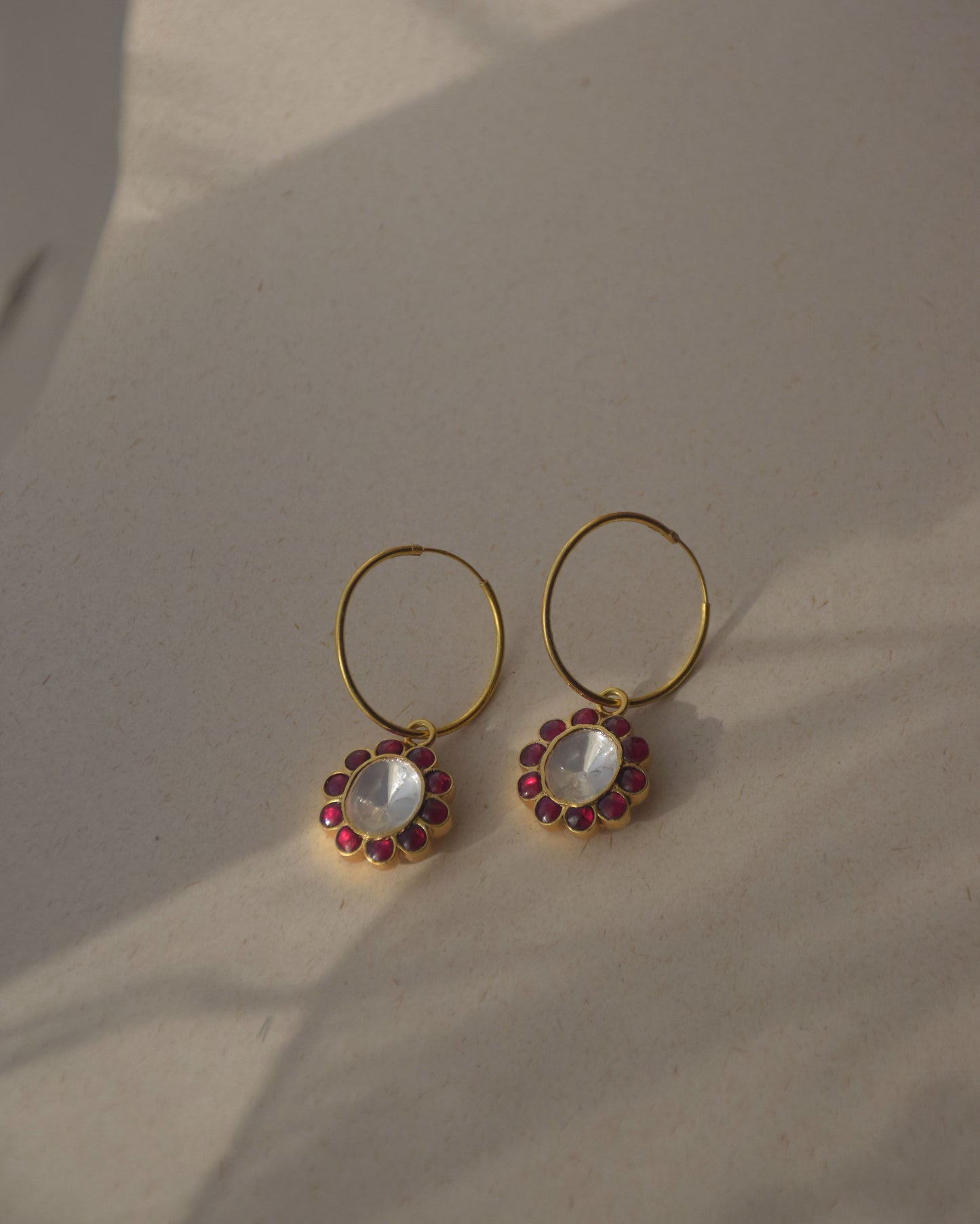 Husna Hoops featuring a large central polki stone surrounded by delicate vibrant pink petals, creating a stunning statement earring .