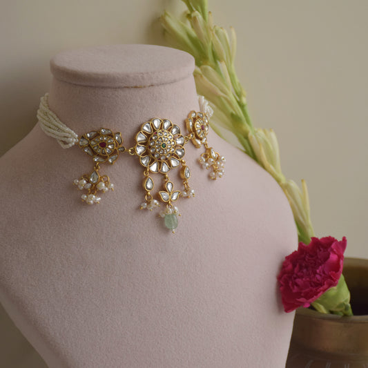 Lata Jadau Necklace handcrafted in 925 silver featuring a circular floral motif with intricate jadau stonework and delicate petal-shaped side motifs.