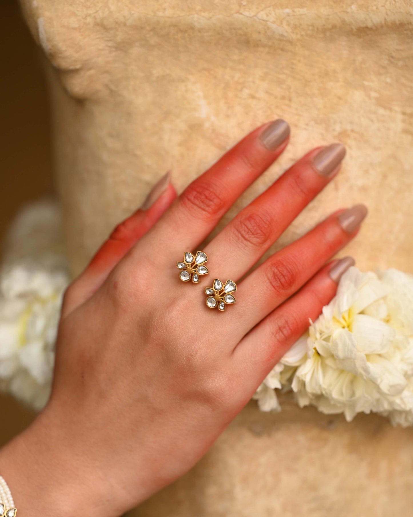 Madhu ring handcrafted in 925 sterling silver with 22K gold plating, featuring intricate floral motifs adorned with jadau stones.