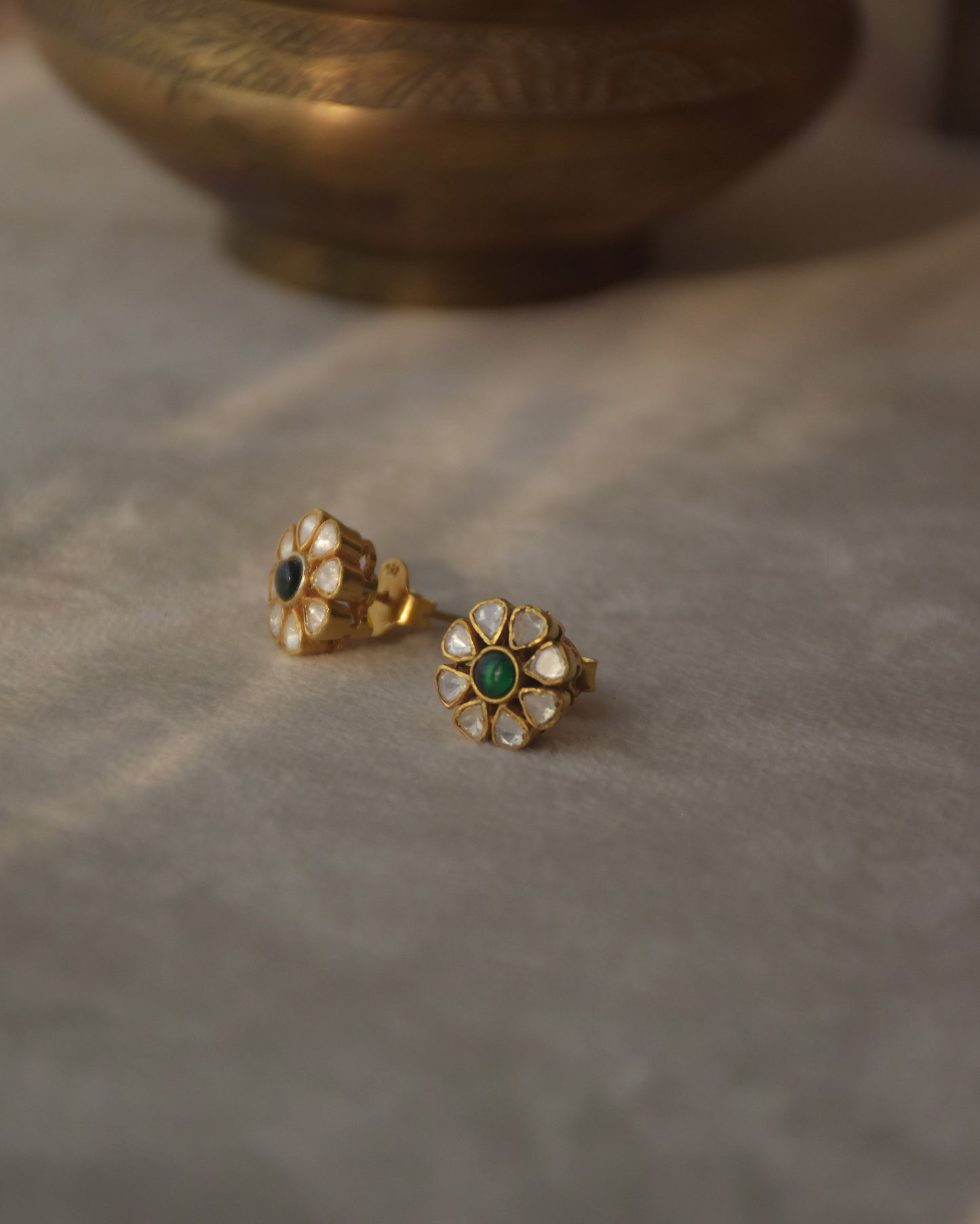 Maitri Earstuds crafted in 92.5 sterling silver, featuring sparkling belur polki stones and a striking green center stone