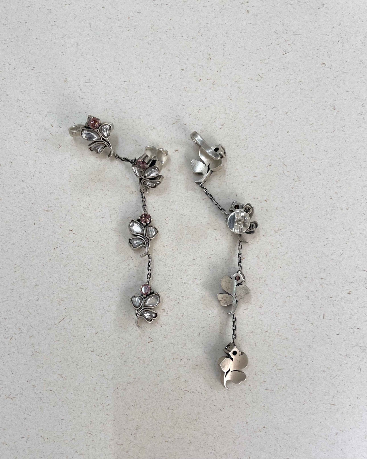 Handcrafted Nuvi Jewels Madhura Earrings in 92.5 silver featuring floral motifs, cascading chains, and cuff clip