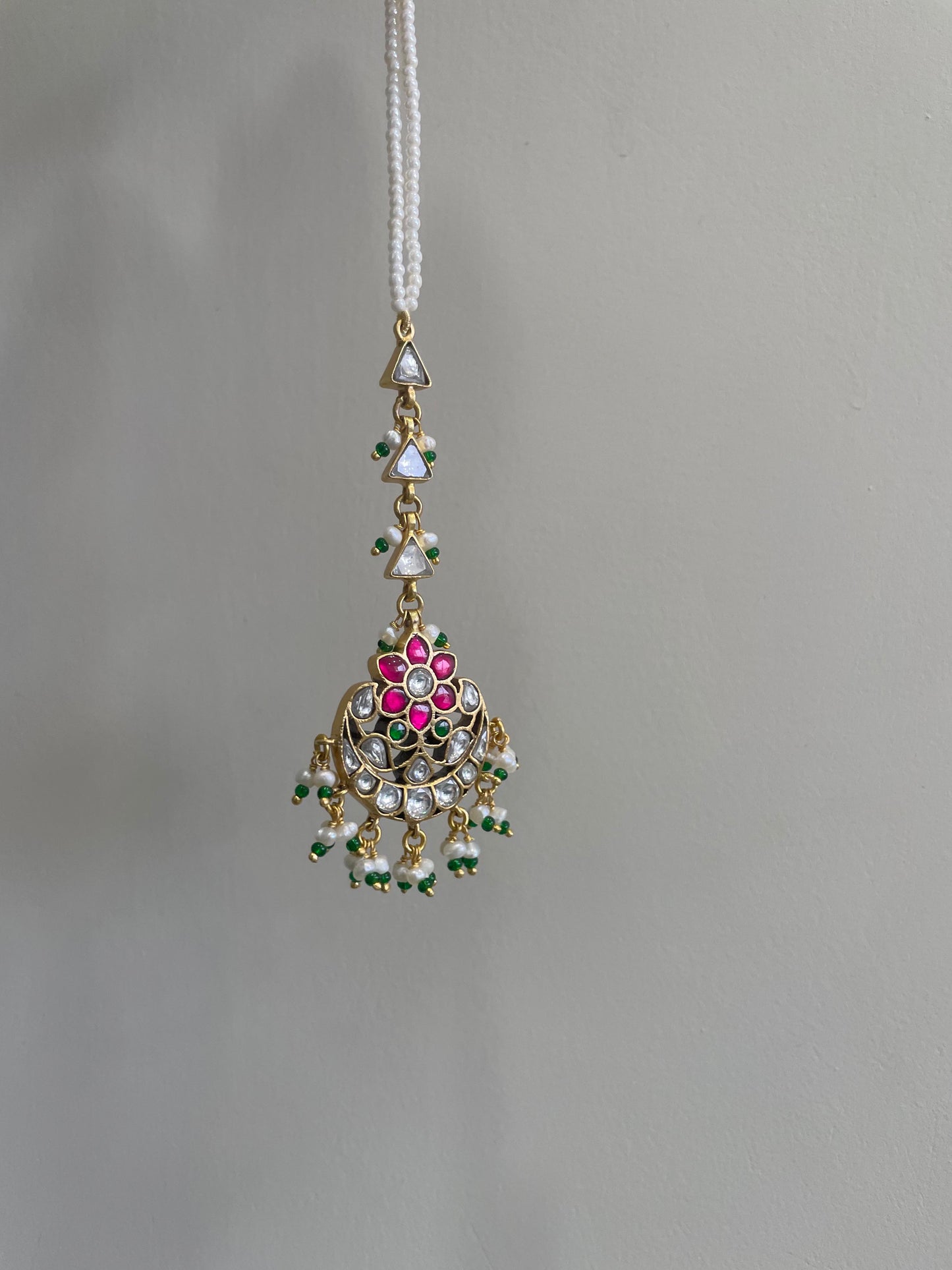 Nuvi Jewels handcrafted mangtikka in 925 sterling silver with gold plating and traditional stone work