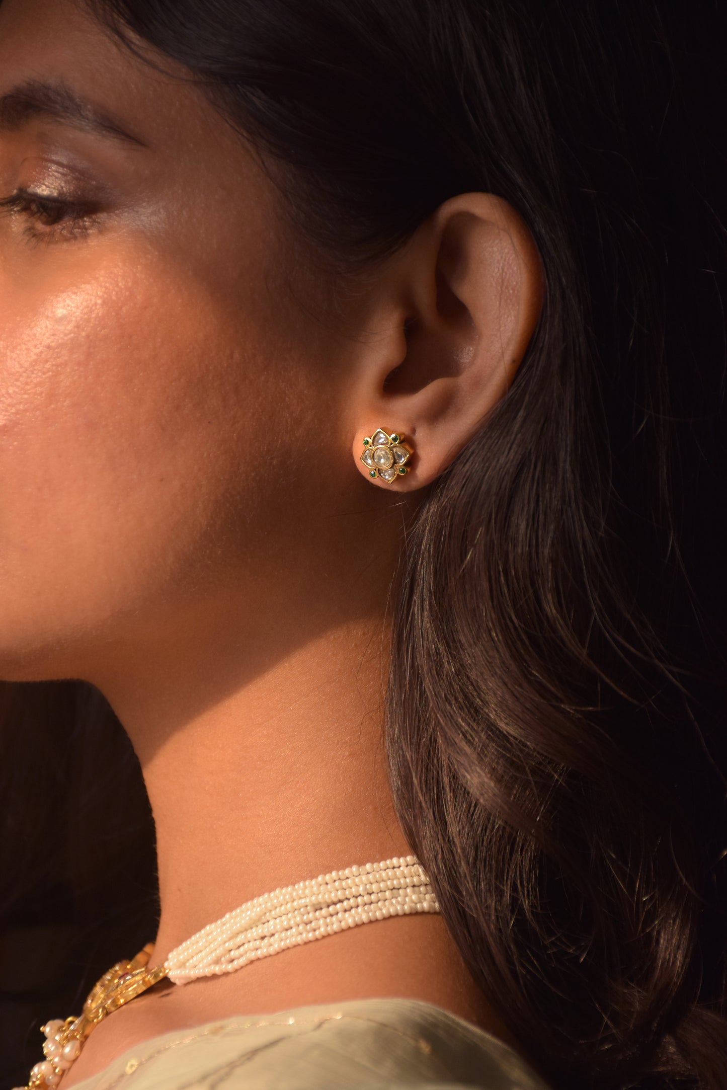 Pihu Jadau Earstuds – Elegant 4-petal floral earstuds with stone-studded Jadau design and green ad stones.