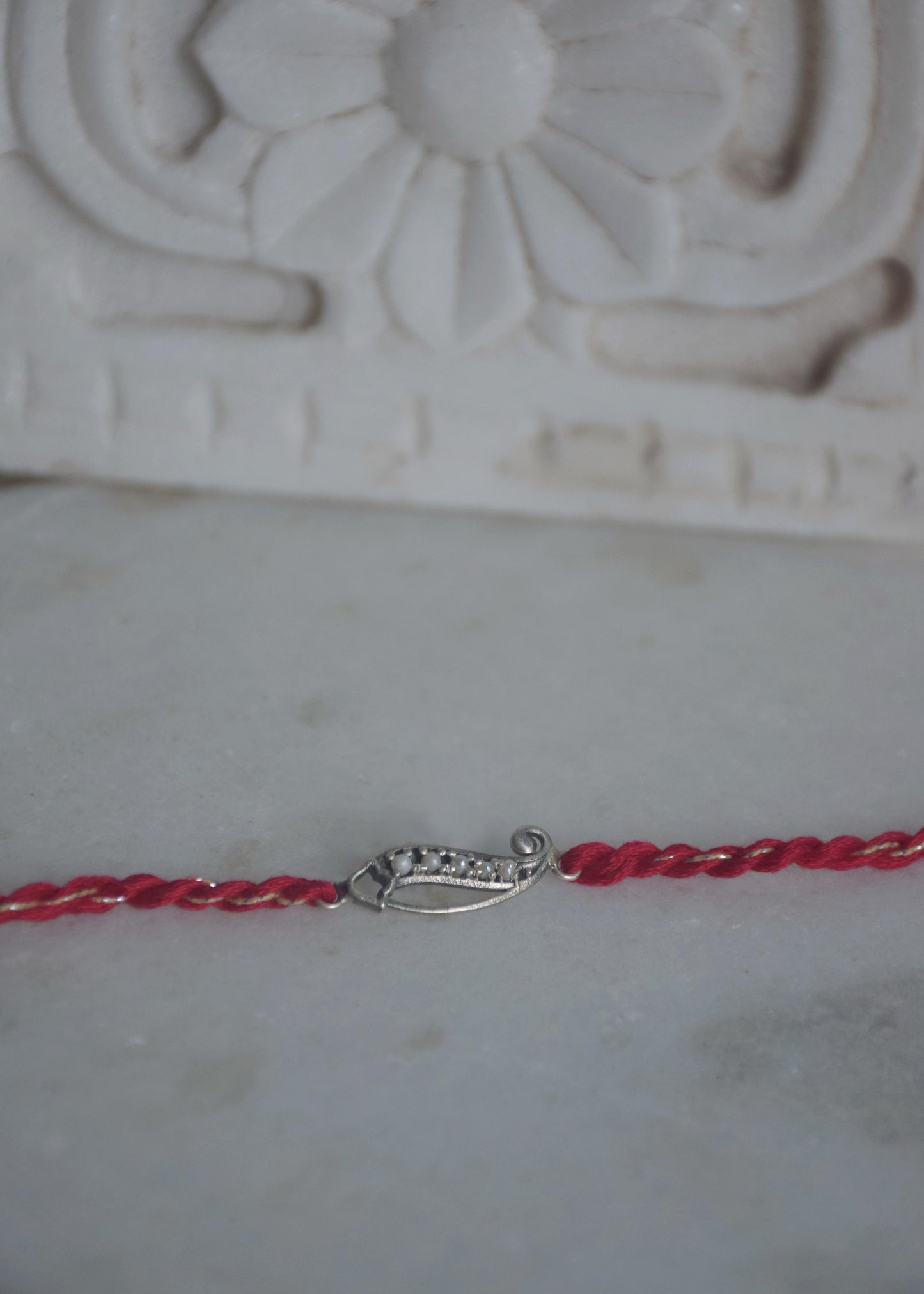 Paisley 925 Silver Rakhi – Designer Kairi Chandi Moti Rakhi Online India | NUVI JEWELS