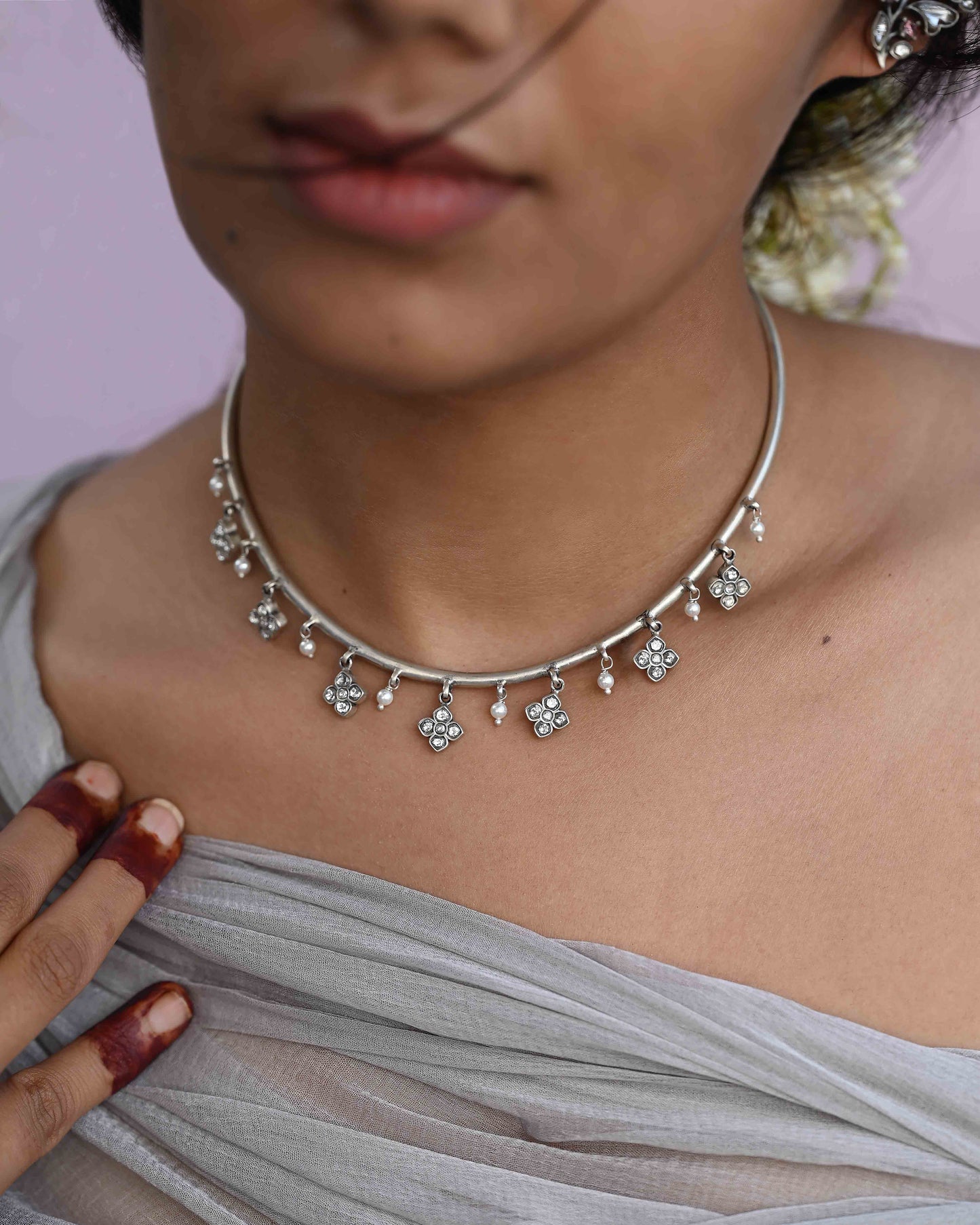 Madhura Hasli necklace crafted in 92.5 sterling silver, featuring delicate floral motifs and dangling pearls.