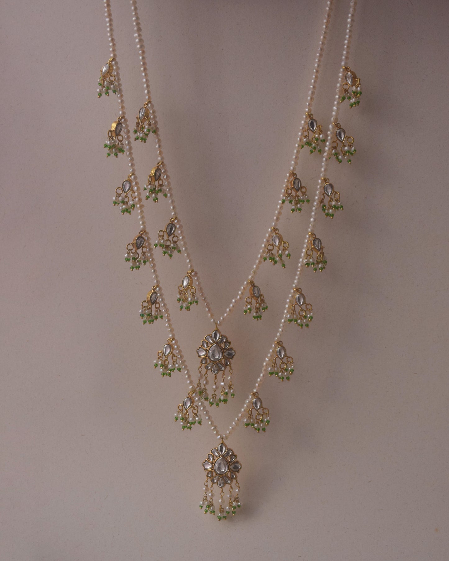 Radharani two-line ranihaar necklace handcrafted in 925 sterling silver, featuring lustrous freshwater pearls and hanging Jadau-studded units.