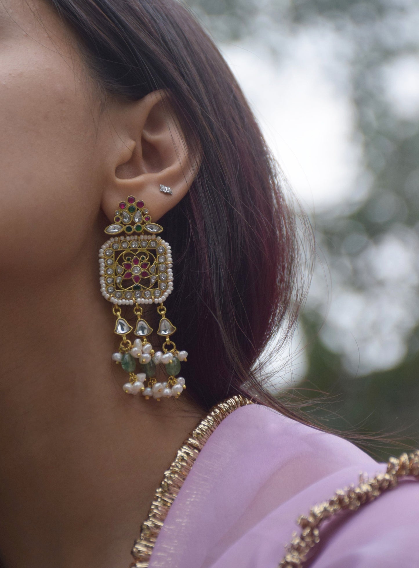 Regal statement earrings handcrafted in 92.5 sterling silver, inspired by Rajasthani heritage and adorned with traditional jadau stones.