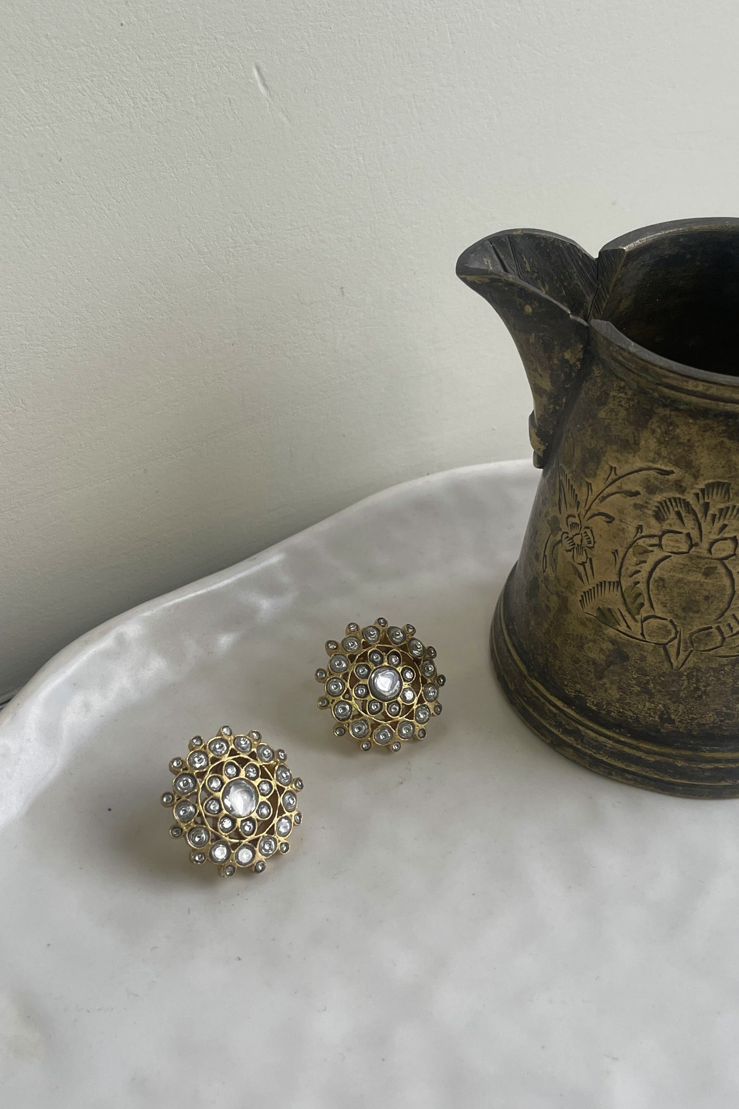 Tara 925 silver Jadau flower studs with intricate stonework.