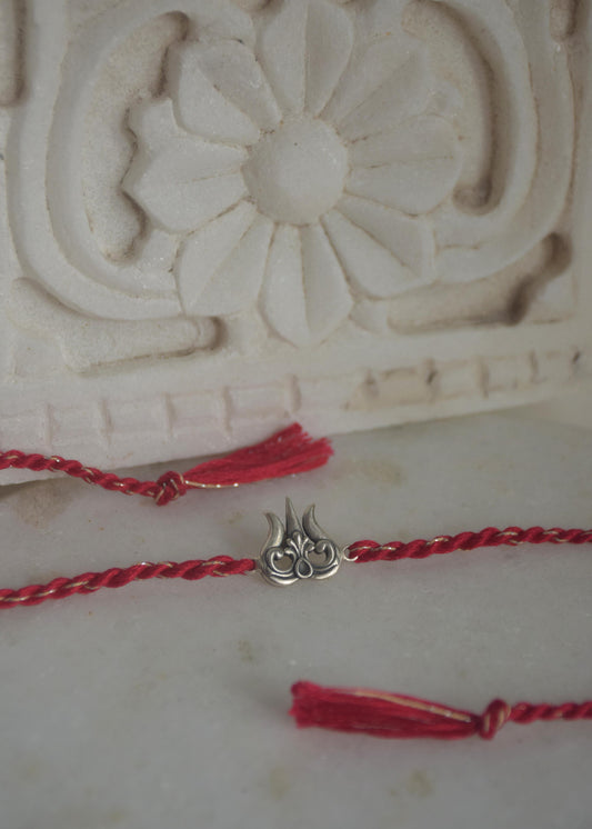 Elegant 92.5 sterling silver Rakhi for Raksha Bandhan, handcrafted with cotton thread and premium silver.