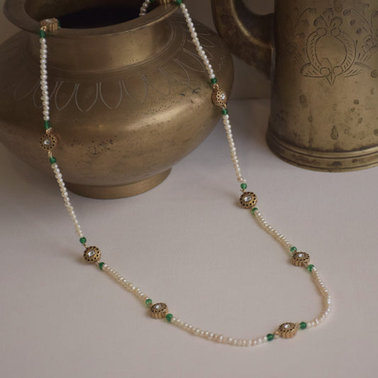 Bindiya Long Mala necklace crafted in 925 silver, featuring lustrous freshwater pearls and captivating Jadau stone units adorned with intricate gold wire flower detailing.