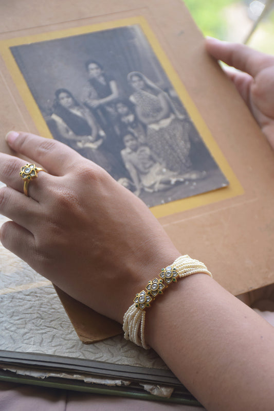 Pihu Bracelet handcrafted in 925 silver, featuring three delicate flower units adorned with pearl accents.