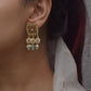 crafted Aayat Earrings in 925 silver. These square-shaped treasures boast an intricate floral centerpiece, encircled by petal-shaped jadau stone work.