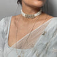 Phirni Choker crafted in 925 silver with a gold-polished finish, featuring three round Jadau stone units as the centerpiece and delicate strands of seed pearls
