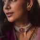Ranisa Choker crafted in 925 silver with radiant gold polish, featuring a captivating round centerpiece adorned with green, pink, and white Jadau stones.