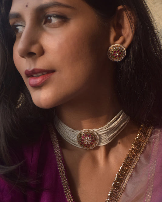 Ranisa Choker crafted in 925 silver with radiant gold polish, featuring a captivating round centerpiece adorned with green, pink, and white Jadau stones.