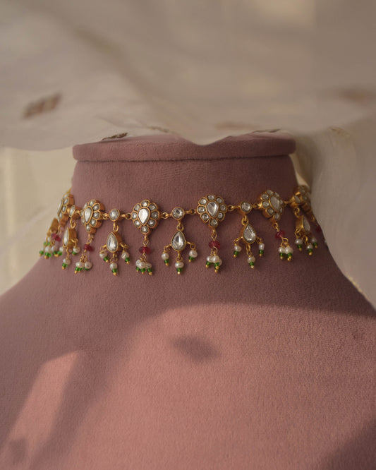 Sagrika Necklace crafted in 92.5 sterling silver, featuring drop-shaped jadau stone-studded motifs, adorned with delicate pearl drops and pink semi-precious beads.