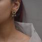  crafted in 925 silver, showcase an enchanting flower motif adorned with Jadau Stones and delicate hanging drops.