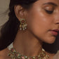  925 Silver, these earrings showcase a round floral motif adorned with Jadau stones and a dangling array of pearls.