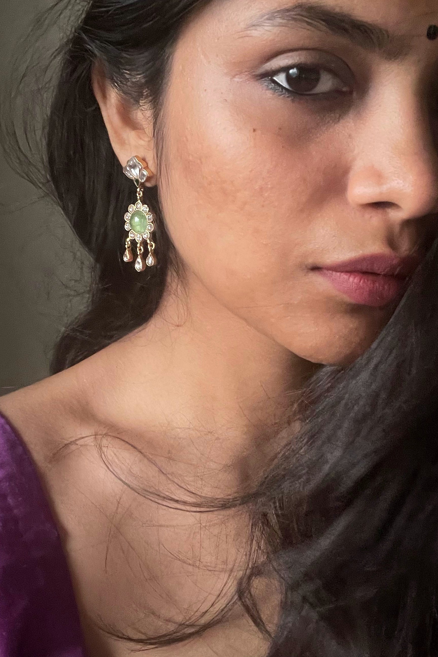  stunning Jadau stone-studded earstuds and a captivating aventurine stone suspended within delicate white Jadau petal work. Handcrafted from 925 Silver.