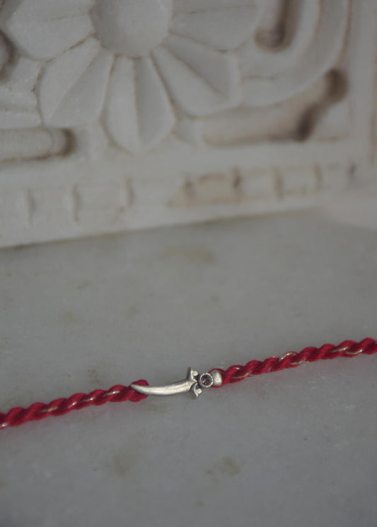  92.5 sterling silver Rakhi featuring real freshwater pearls and cotton thread,
