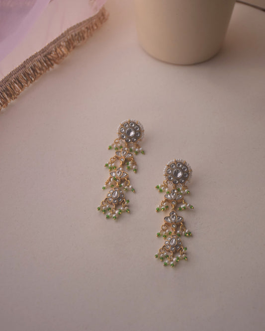 Dhanak Earrings crafted in 925 sterling silver featuring a round stud with four elegantly suspended units adorned with delicate hanging pearls.