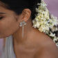 The Guldasta Earrings are Crafted in 92.5 Sterling Silver With White Jadau Stones And Delicate Chains.