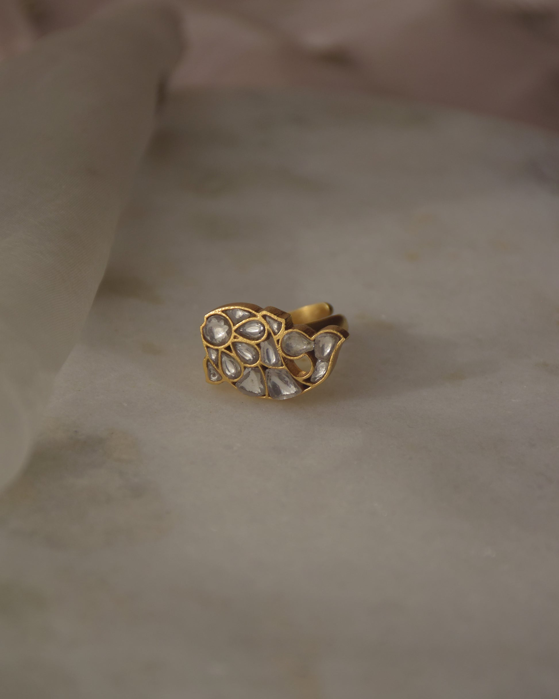 Matsya Ring- Crafted in 92.5 Gold Plated Silver has a fish motif that is studded with white jadau stones