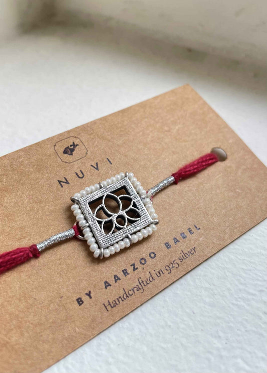 92.5 sterling silver Rakhi featuring real freshwater pearls and cotton thread,
