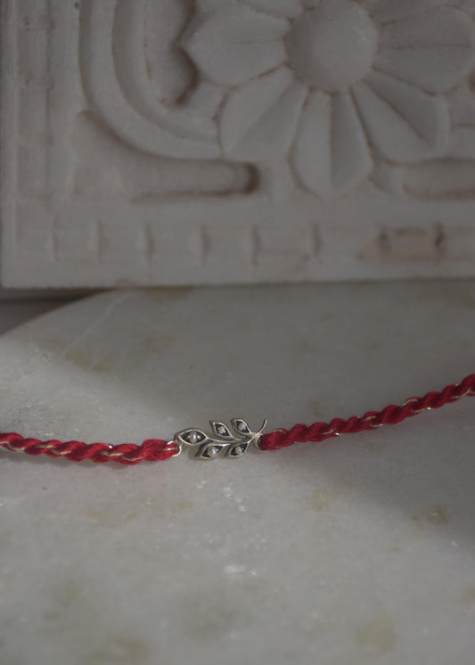  92.5 sterling silver Rakhi featuring real freshwater pearls and cotton thread,