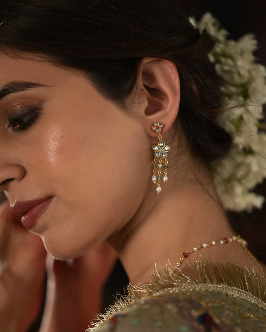 Avani Earrings crafted in 925 silver with gold polish, featuring delicate floral motifs adorned with jadau glass-filled stones, accented by drops of rice pearls and green aventurine beads