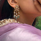  925 silver Nagma Phulkari Earrings, a celebration of vintage charm. Featuring a classic petal-shaped jadau motif adorned with multicolored jadau stones and accented by drop-shaped jadau units.