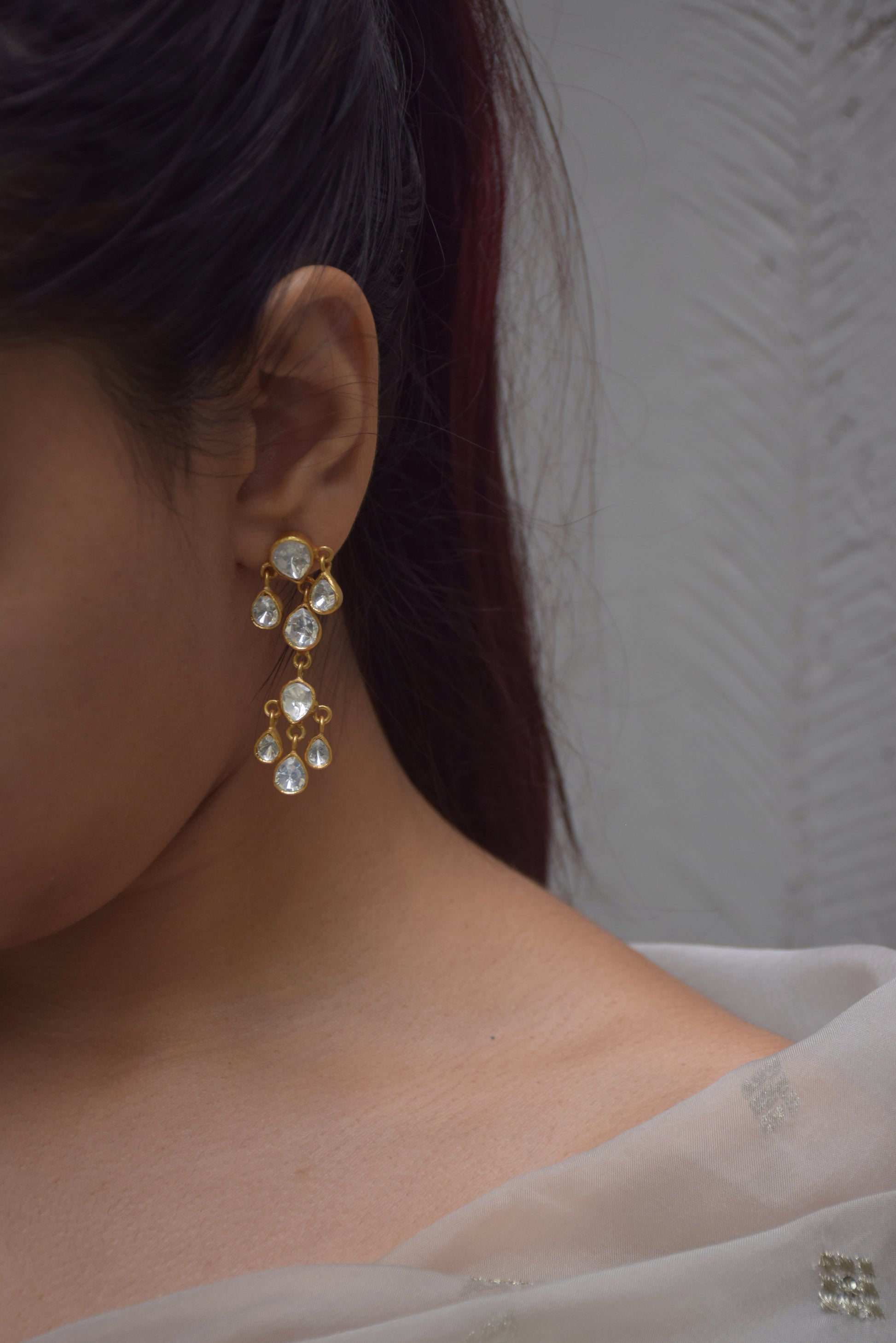 Nargis Earrings crafted in 925 silver, featuring exquisite chandelier-style Polki stone drops that shimmer beautifully. These delicate and elegant earrings.