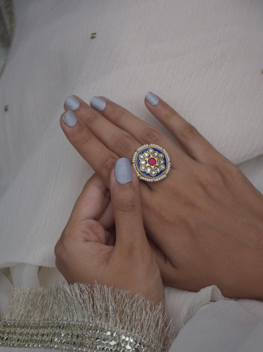 Neelam Ring featuring a rich blue meena center stone with intricate jadau crafts.