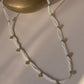 Nirjara Mala is a 30-inch necklace crafted with delicate flower-shaped Jadau units strung along elegant lines of seed pearls.